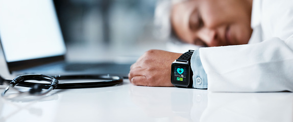 Image showing Tired doctor, woman and sleep in night with smartwatch, laptop and stethoscope on desk in clinic office. Healthcare burnout, senior medical expert and sleeping by computer table in hospital workspace