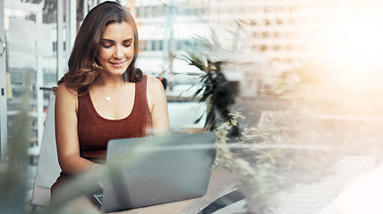 Image showing Woman, laptop and typing in coffee shop, cafe or restaurant for internet blogging, internet research or education course. Smile, happy and entrepreneur on technology with lens flare or freelance app