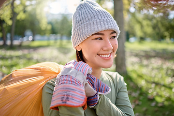 Image showing Plastic bag, park and happy woman cleaning for earth day, planet or community service, support or volunteering. Recycle, sustainability and nonprofit, ngo person idea in nature forest for pollution