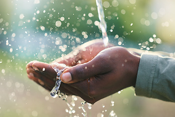 Image showing Hands, splash and man with water in nature for outdoor washing, cleaning or body hygiene. Natural, organic and African male hand with aqua to wash or clean to prevent germs, dirt or dust outside.