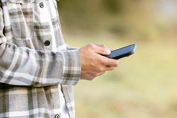 Image showing Phone outdoor, man hands and park of a person typing on social media and mobile communication. 5g connection, website and media technology scroll of a male reading with blurred background in nature