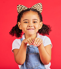 Image showing Girl, portrait and leopard headband in studio for fancy dress, pretend play and imagination in red background. Happy children, animal print fashion and hands excited for fun, happiness and cute pose