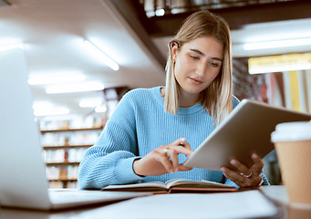 Image showing Education, university and woman in library with tablet, research and books for school project or exam. Laptop, notebook and internet, college student studying with technology and elearning on campus.