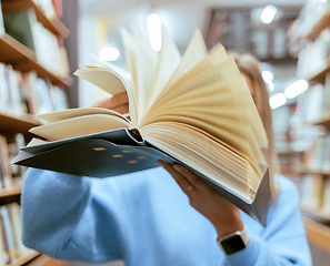 Image showing Education, book and pages in a library for reading for knowledge, learning or studying. Information, books and woman looking at paper in a novel or story at a book store to study, learn or read.