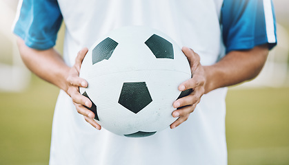 Image showing Hands, ball and soccer player ready for sports match, game or competition on the outdoor field. Hand holding round sphere object for sport, training or practice in physical activity outside in nature