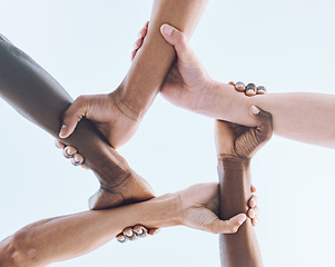 Image showing Below, hands and team, sports and collaboration, partnership and huddle against sky background. Bottom, fitness and friends hand in support of teamwork, goal and mission, diversity and training