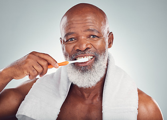 Image showing Black man, dental hygiene and toothbrush with wellness, brushing teeth and smile on grey studio background. Oral health, African American male and guy clean mouth, fresh breath and grooming routine