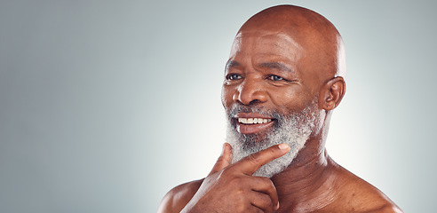 Image showing Senior black man, smile and beard in skincare for facial treatment, cosmetics or thinking on mockup. Happy elderly African American male smiling face in satisfaction against a grey studio background