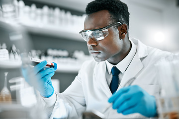 Image showing Black man, research and tube for test sample, focus and thinking for cure, innovation and diagnosis. African American male, researcher or scientist with vial, data analysis or decision for experiment