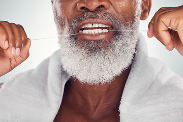 Image showing Floss, dental and teeth of senior man isolated on white background for mouth wellness, self care and cleaning. African model or elderly person with product for tooth, gum and oral dentist healthcare