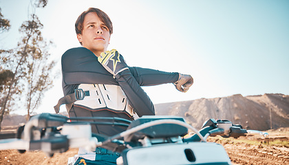 Image showing Moto cross, arm stretching and man in nature on motorbike for competition workout. Desert ride, motorcycle training and exercise focus of an extreme motorbike sports athlete on a dirt road for sport