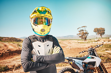 Image showing Arms crossed, bike and portrait of a man in nature for adventure, cycling and exercise in Spain. Fitness, sports and athlete with a motorcycle for training, cardio and travel in the mountains