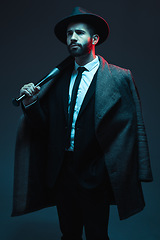 Image showing Fashion, criminal and man in studio with bat for vintage, retro and Victorian gangster on dark background. Crime aesthetic, thinking and male model with luxury clothes, designer and elegant suit