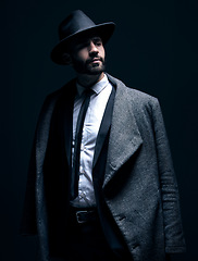 Image showing Fashion, suit and classy man thinking of clothes isolated on a dark background in a studio. Mafia, idea and corporate model with fashionable, elegant and professional clothing for work on a backdrop