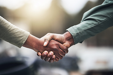 Image showing People, hands and handshake for agreement, deal or trust in partnership, unity or support on a blurred background. Hand of team shaking hands for community, teamwork or collaboration in the outdoors