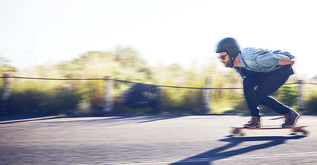 Image showing Sports, skateboard and man riding on road for fitness, exercise and wellness. Training, freedom and male skater on board moving with fast speed, skateboarding and skating outdoors for action workout