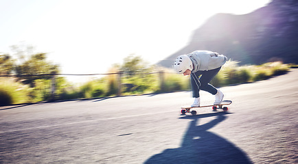 Image showing Fast, sports and man skateboarding in the road for freedom, travel and urban action in Norway. Fun, competition and skateboarder blur with speed, motion and moving on a skateboard in the street