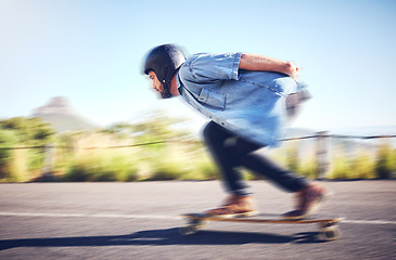 Image showing Skateboard, sports man and skating fast on road for fitness, exercise or wellness. Training, freedom and travel adventure of skater person moving with speed, balance and safety outdoor on asphalt