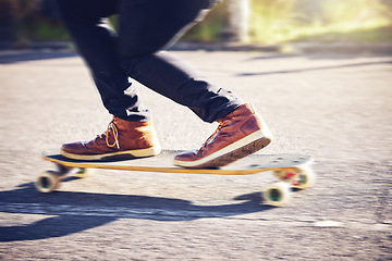 Image showing Skateboard, feet and man skating on road for fitness, exercise and wellness. Training sports, shoes and legs of male skater on board, skateboarding or riding outdoors for balance or workout on street