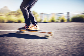 Image showing Fast, blur and legs of a man on a skateboard in street for exercise, training and travel in Australia. Fitness, sports and legs of a person skateboarding in the city road for fun, speed and cardio