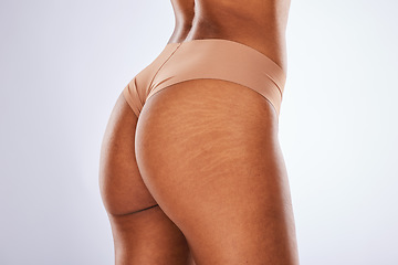 Image showing Cellulite, buttocks and underwear with a model black woman in studio on a gray background for body positivity. Stretch marks, real and natural with a female posing in lingerie from the back