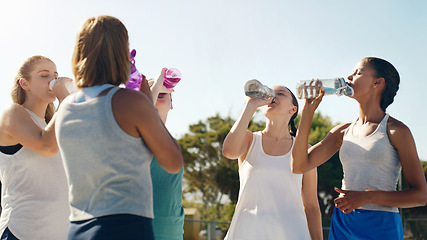 Image showing Athletic woman, friends and drinking water for hydration during sports workout, training or practice together outside. Group of sporty women staying hydrated for healthy sport exercise in nature