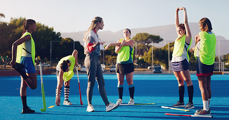 Image showing Hockey, women team with coach and sport outdoor, coaching and game strategy, training and fitness on turf. Athlete stretching, start practice and wellness with match plan, motivation and support