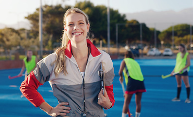 Image showing Hockey, coach and portrait of woman at stadium for training, fitness and cardio with group, happy and excited. Sports, trainer and female smile, confident and cheerful during game, match and sport