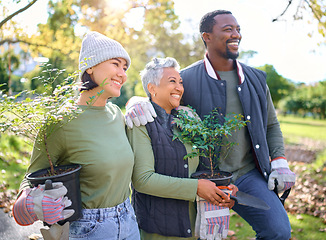 Image showing Volunteer group, plants and gardening in a park with trees in nature environment, agriculture or garden. Happy man and women planting for growth, ecology and sustainability for community on Earth day