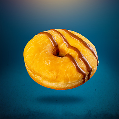 Image showing Delicious donut on blue background