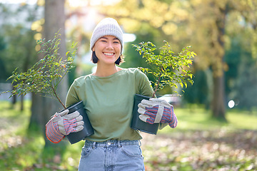 Image showing Woman portrait, plant and gardening in a park with trees in nature environment, agriculture or garden. Happy volunteer planting for growth, ecology and sustainability for community on Earth day