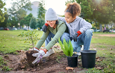 Image showing Woman, child and nature park with a plant for gardening trees or agriculture in garden. Happy volunteer family team helping and planting growth, ecology and sustainability for community on Earth day