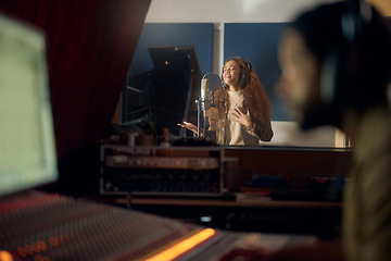 Image showing Woman, singing or studio recording microphone for album, audio or radio music cover in night production. Singer, artist or musician with producer in evening song, media or sound performance practice