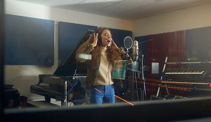 Image showing Headphones, singing or woman with studio microphone in album recording, evening audio or radio music at night. Singer, musician or artist in production song, voice media or sound performance practice