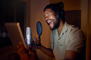 Image showing Tablet, singer or black man on studio microphone, music app or live streaming lyrics in dark recording. Singing, musician or artist on technology production, voice media or sound performance practice