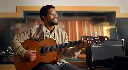 Image showing Musician, acoustic and man playing the guitar for music production or recording in studio. Artist, guitarist and African guy strumming the strings of a musical instrument for sound track performance.