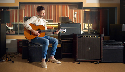 Image showing Recording studio, acoustic and man playing the guitar for music production or practicing for a performance. Artist, guitarist and guy strumming the strings of a musical instrument for a sound track.