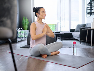 Image showing Prayer hands, yoga and meditation of Asian woman in home living room for mindfulness exercise. Zen chakra, pilates and female yogi training and meditating with namaste hand pose for relax and peace.