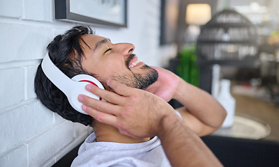 Image showing Relax, music and man with headphones in home living room streaming radio or podcast. Freedom, technology and face of happy male in lounge listening to relaxing song, audio track or album in house.