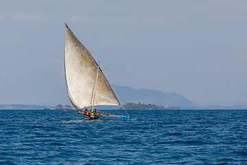 Image showing Malagasy fisher on sea in traditional handmade dugout wooden sailing boat