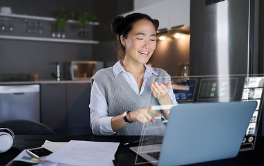 Image showing Laptop, futuristic hologram and woman in home kitchen laugh at funny meme. Freelancer, remote worker and Asian female pointing to computer with 3d, augmented reality or data graphs at night in house