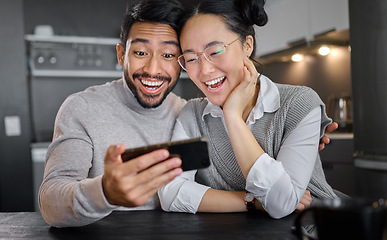 Image showing Love, technology and couple with phone in home kitchen watching funny video online. Social media, wow and surprised asian man and woman with mobile streaming comic movie and laughing at night.