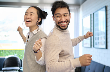 Image showing Couple, love and dance in home living room, having fun and laughing while enjoying time together. Music freedom, diversity and interracial man and woman dancing, smile and bonding in lovely house.