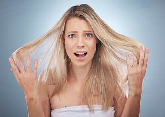 Image showing Face portrait, hair loss and shocked woman in studio isolated on a gray background. Beauty, surprised and female model sad, angry or frustrated with haircare damage, split ends or messy hairstyle.