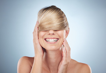 Image showing Hair cover face, beauty and woman in studio isolated on a gray background. Texture, haircare mask and female model happy and satisfied after luxury salon treatment for balayage, hairstyle and growth.