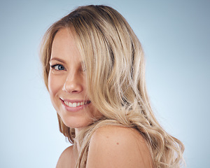 Image showing Portrait, hair and happy with a model woman in studio on a gray background for keratin treatment. Face, haircare and smile with an attractive young female posing to promote natural beauty or skincare