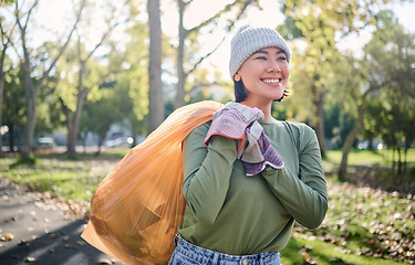 Image showing Plastic bag, park and woman cleaning in eco friendly, climate change or community service project for volunteering. Garbage, recycle and nonprofit or ngo person smile in nature forest for pollution