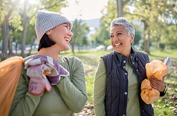 Image showing Cleaning, plastic bag and people in park for community service, volunteering and pollution help, support and goals. Happy senior woman with youth in nature or forest with waste, garbage or recycling