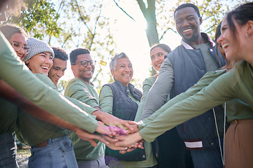 Image showing Team, motivation and friends in a huddle while hiking together in the forest or woods from below. Fitness, exercise or nature with a diversity man and woman friend group putting hands in a circle