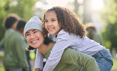 Image showing Mother smile, piggy back hug and interracial family with girl and mom together in nature. Park, happy summer and mama with love and care for child playing outdoor in a garden with blurred background